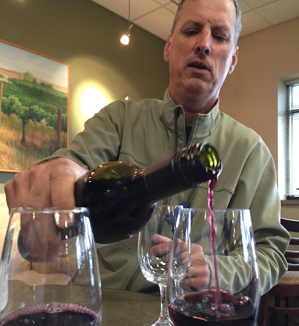 Co Dinn, owner of Co Dinn Cellars, pours a sample of his Cabernet Sauvignon at the Yakima Valley Vintners tasting room in Grandview, Wash. (Photo by Andy Perdue/Great Northwest Wine)