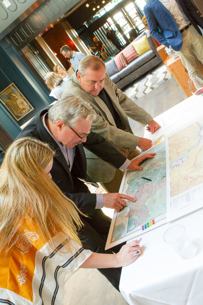 David West, the first employee at Panther Creek Cellars, winemaker Tony Rynders, and Christie Shertzer, hospitality manager at Panther Creek, look over a map of the Willamette Valley. (Photo by Chris Bidelman) 